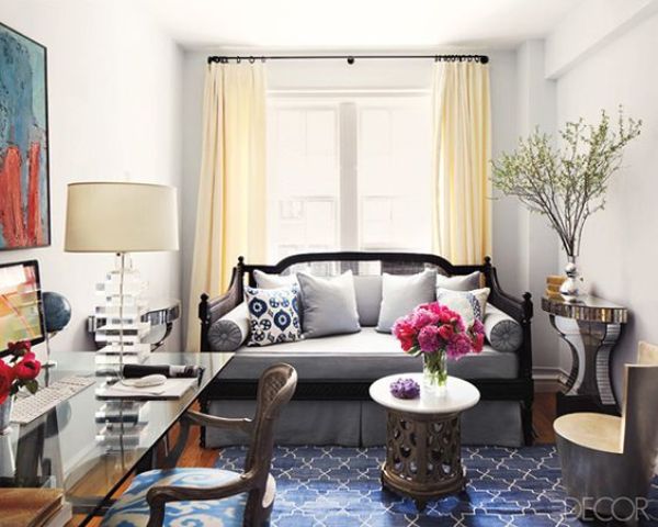 a whimsy guest bedroom with a sleeping space and a glass desk that looks airy and ethereal