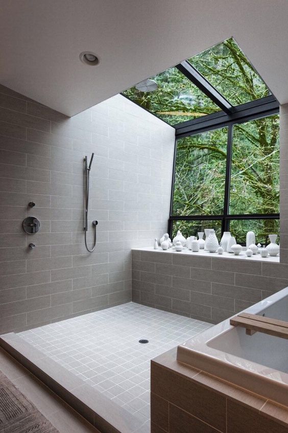 a full panoramic window and a skylight are totally welcome to enjoy the forest views