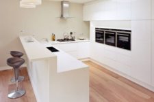 23 a kitchen island with a raised bar part can be used for both having breakfast and drinks