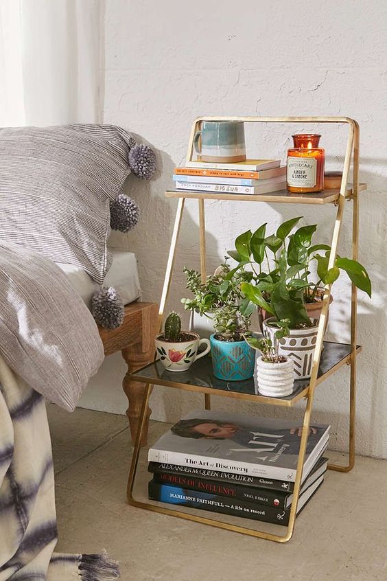 a stylish little ladder bedside table looks really cool and can accommodate a lot of things