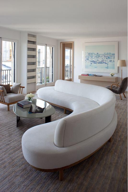 a curved white couch makes a stylish statement in the living room