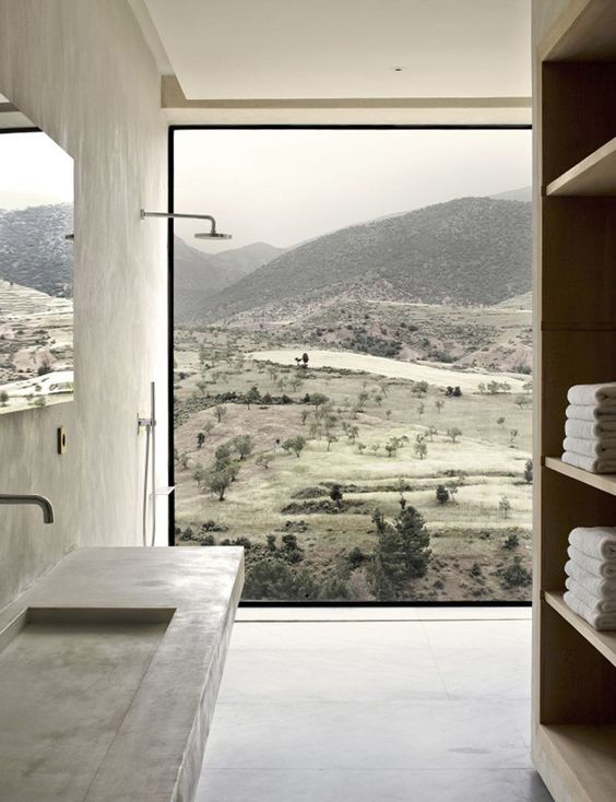 a fully glazed wall in the shower lets enjoy the stunnung views and there no neighbors, so no privacy needed