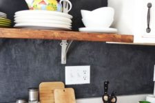 24 black plaster backsplash, white cabinets and wooden shelves for a bright modern look