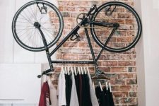 26 a super cool t-shirt rack made of a bicycle for an edgy touch to your interior