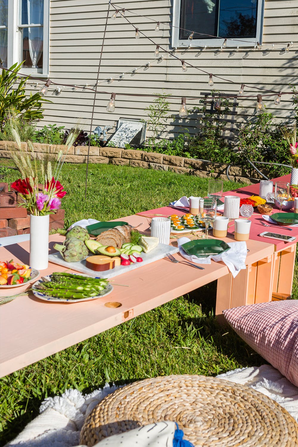 a colorful backyard floor table made of 8 IKEA Knagglig boxes is a bright touch to your outdoor space