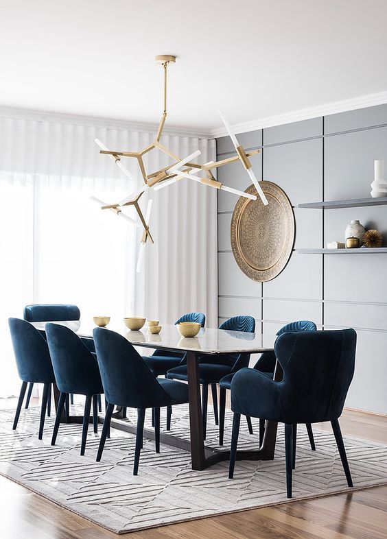 a geometric grey panel statement wall in the dining room looks cool and very contemporary