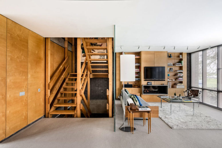 The living room is done with amazing views, comfy furniture makes it inviting and a frosted glass divider separates the stairs from the room