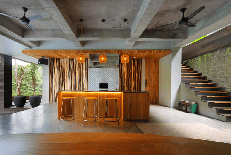 Here's a bar and cooking zone highlighted with pendant lights and opened to outdoors