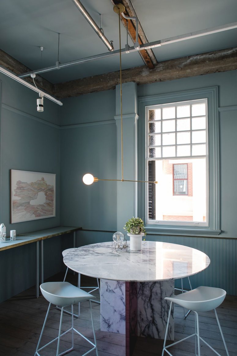 interior with highlighted industrial pipes The dining space is done in pale green, with brass touches and highlighted industrial pipes