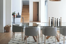04 The dining space is done with a chic glass dining table and felt chairs, accessories here play an important role