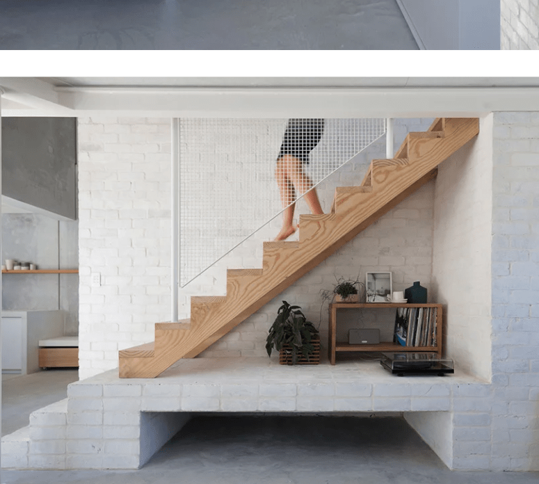 an entryway with a whitewahed brick wall Whitewashed brick used throughout the house makes it neutral and airy yet interesting and textural