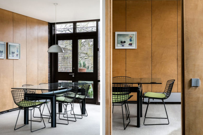 Further you will see a cool dining zone with a black metal table with a glass top and green chairs