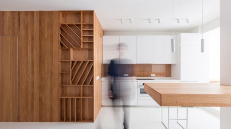 The bathroom is hidden inside a large wooden cube with much storage