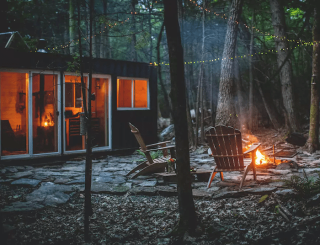 The house features a fire pit, a waterfall not far from it