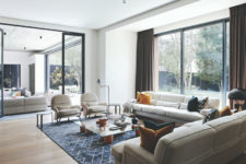 The living room is done with a panoramic window, and glass doors separate the living and dining spaces