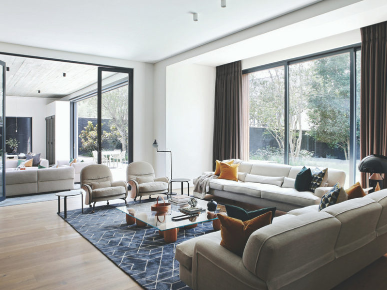 The living room is done with a panoramic window, and glass doors separate the living and dining spaces The living room is done with a panoramic window, and glass doors separate the living and dining spaces