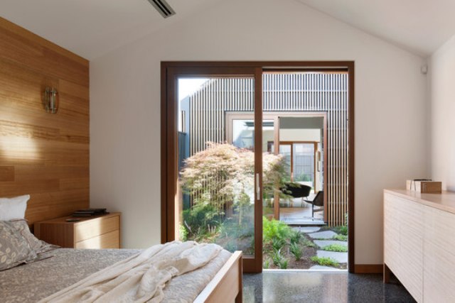 The sleeping part is done with a wood clad wall, a bed and a dresser, there's a door to the courtyard The sleeping part is done with a wood clad wall, a bed and a dresser, there's a door to the courtyard