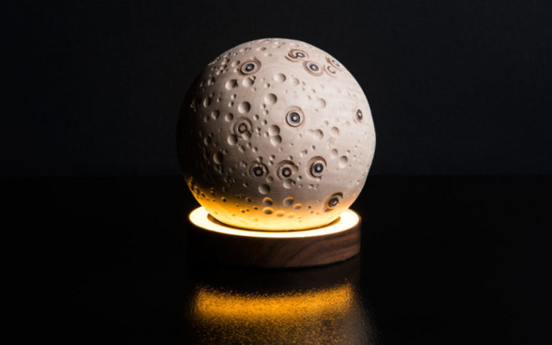 The Mini Moon rests atop a solid walnut base with lights