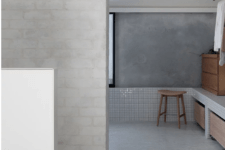 06 The bathroom shows off how to combine plaster, concrete and brick plus white tiles harmoniously in one space and add wood to it for a warmer look