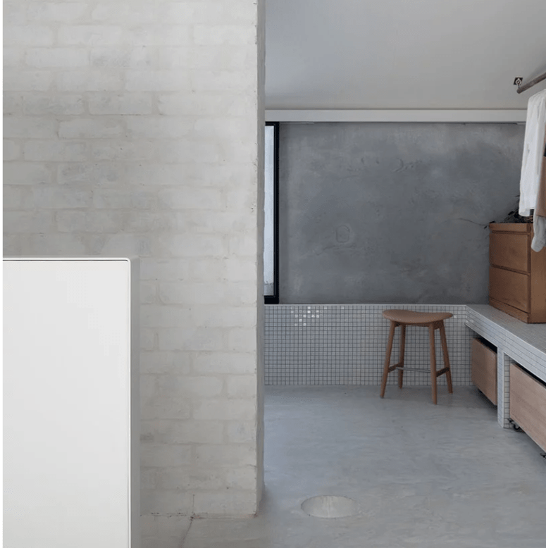 The bathroom shows off how to combine plaster, concrete and brick plus white tiles harmoniously in one space and add wood to it for a warmer look The bathroom shows off how to combine plaster, concrete and brick plus white tiles harmoniously in one space and add wood to it for a warmer look