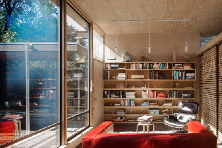 built in book storage in a living room The living space is done with a large bookshelf unit and some pendant lamps