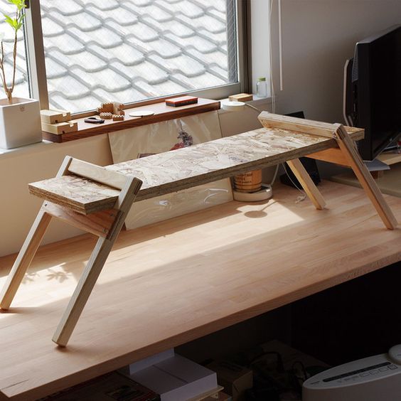a small adjustable wooden desk can be placed on a usual one and removed when not in need