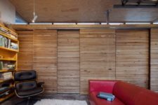 07 The wall and storage is hidden with wood plank sliding doors to avoid cluttering a small space