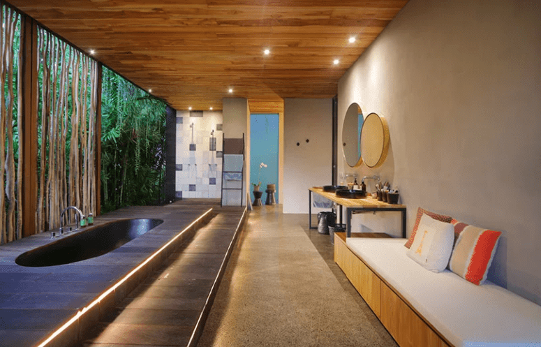 small oasis right in a bathroom Here's a spa bathroom with a large sunken tub, which is opened to outdoors, yet hidden with a bamboo wall