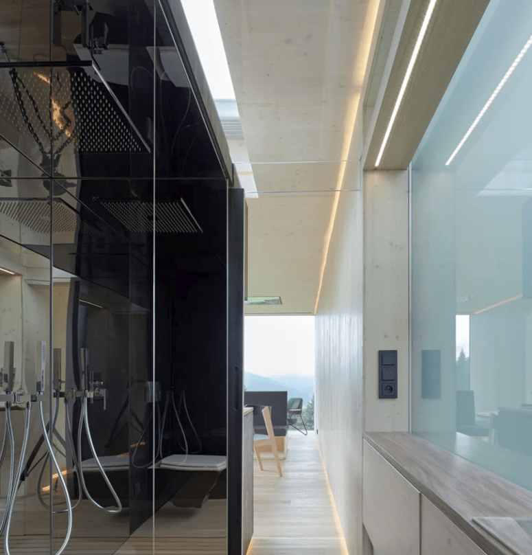 The minimalist shower is hidden behind opaque glass, which brings natural light in