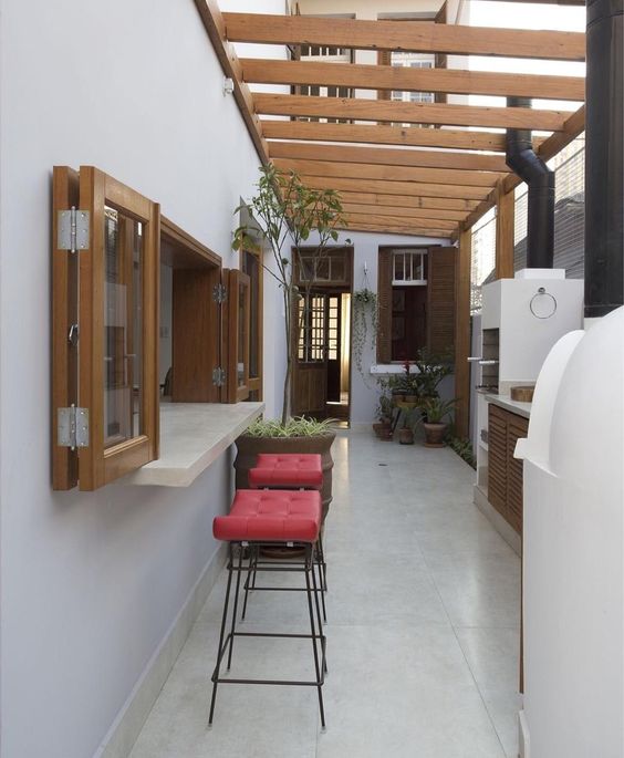 a small bar space with windows, coral stools is covered up to protect it from excessive sunlight