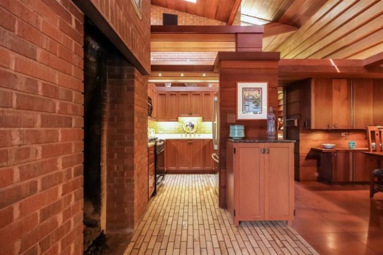 The kitchen is hidden behind these cabinets and as there are no windows, it's lit up with artificial light as much as possible