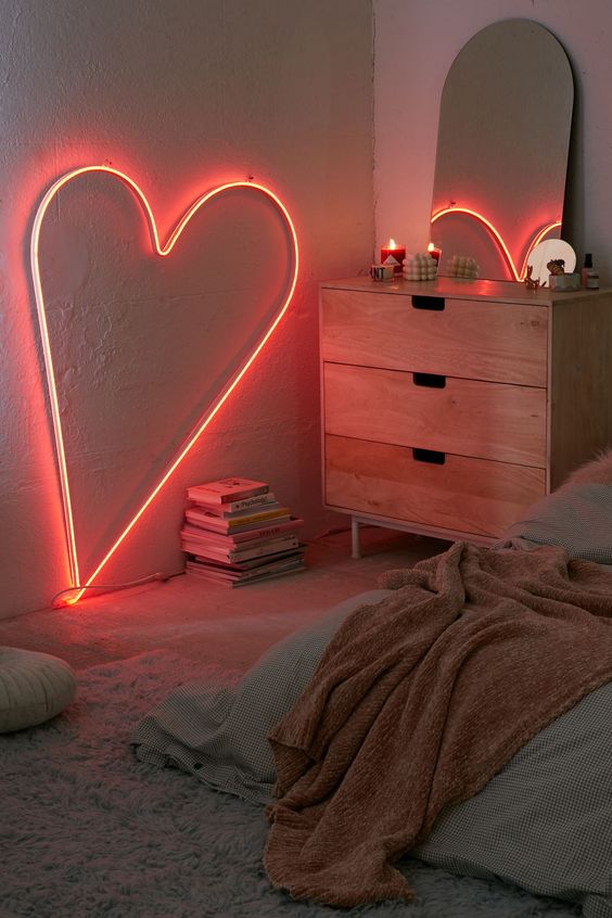 a heart-shaped neon light is a great idea not only for a girlish bedroom but also for a bedroom on the whole