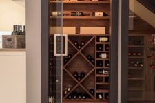 10 a small yet stylish wine cellar under the stairs with various plywood shelves for the bottles