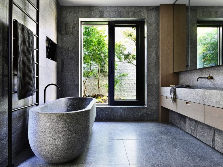 stone bathroom design The bathroom resembles a natural spa with a larrge window, stone-like tiles and a real stone bathtub