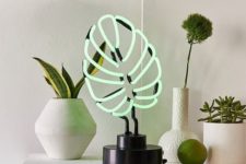 a monstera leaf neon tale lamp won’t wither and will spruce up your space making it whimsy and cool
