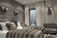 13 a double guest bedroom done in chalet style with a grey weathered wood wall for a statement