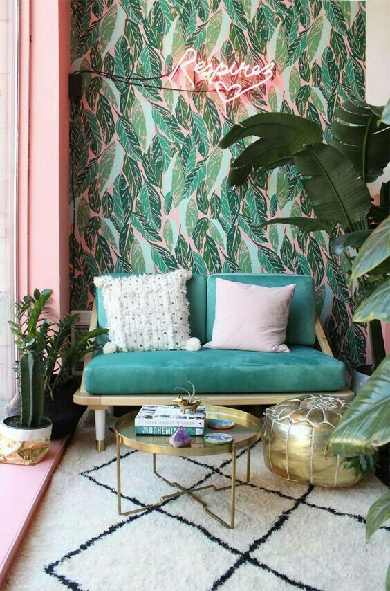 neon lights are ideal for tropical spaces like this one - green and pink wallpaper is complemented with tropical plants and a pink neon light