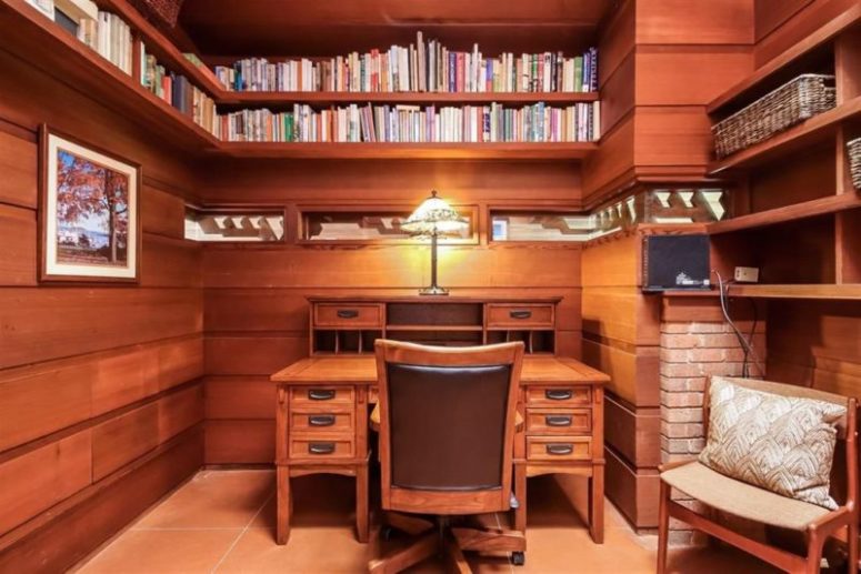 masculine home office with lots of books storage There's also a home office with lots of bookshelves going along the whole perimeter of the room
