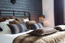 14 a dark grey wood plank statement wall is ideal for a chalet or woodland-inspired bedroom