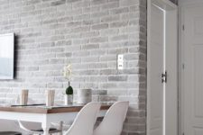 16 a light-colored grey brick wall adds texture to the space and white furniture refreshes the area