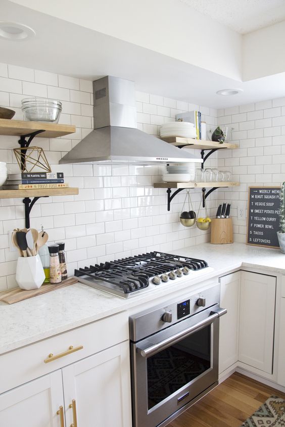 though satin stainless steel dominates here cause of appliances, brass adds a warm touch to the kitchen