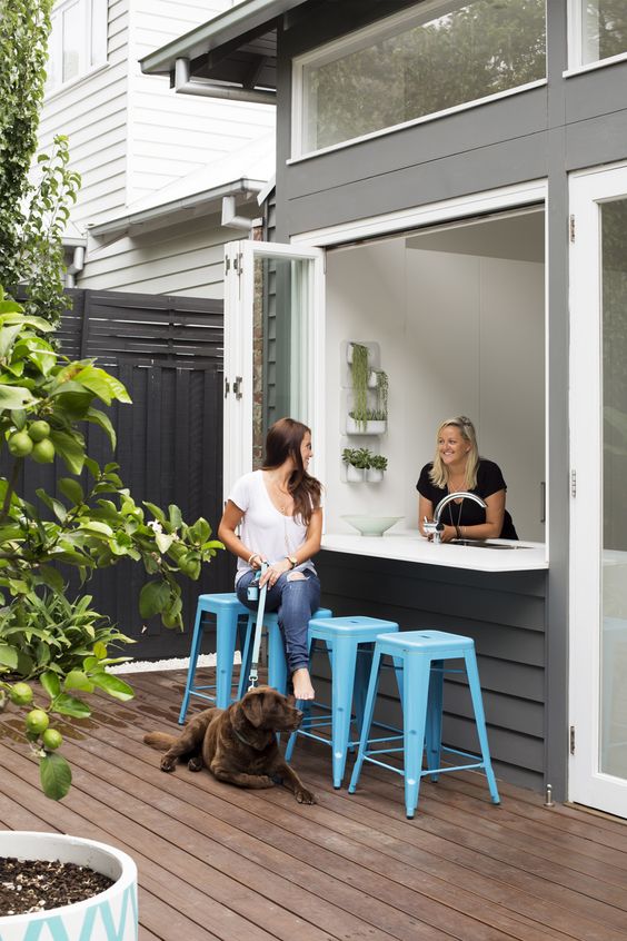 attach an outdoor bar counter nd place some bright blue chairs and voila - an outdoor bar is ready