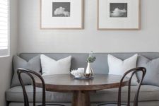 18 a simple grey banquette seating with a wooden table and chairs for an eclectic space