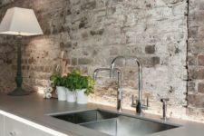 19 a contemporary industrial kitchen with rough grey brick walls and a ceiling plus stainless steel