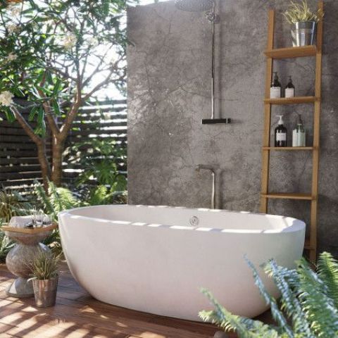 a minimalist space with a concrete wall, an oval bathtub and a ladder as a storage piece