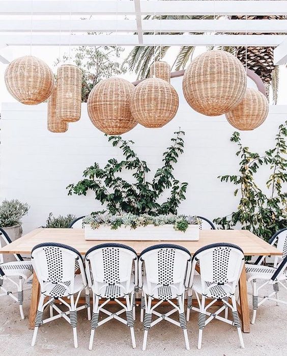 an airy and welcoming space with a whole arrangement of wicker lamps for a catchy look