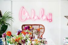 22 a bright dining space spruced up with tropical touches and a pink neon light word for fun