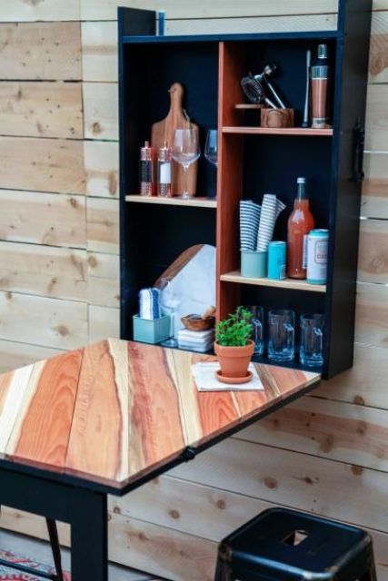 a folding outdoor bar in black and light-colored plywood is a classic piece that doesn't require much space