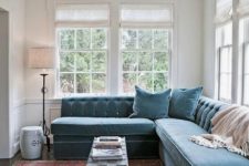 23 a mid-century modern space with a large muted blue velvet banquette seating