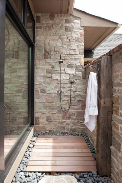 25 Outdoor Shower Decor Ideas To Try Digsdigs A Small Yet Stylish Outdoor Shower Clad With Stone And Bricks Wooden Deck